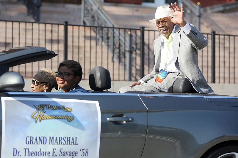 Grand Marshal Theodore Savage waves to the crowd Saturday during Lincoln University's homecoming parade in downtown Jefferson City.