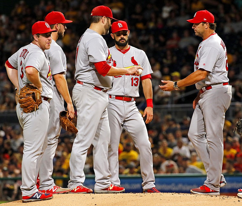 St. Louis Cardinals manager Mike Matheny, right, takes the ball from starting pitcher Lance Lynn in the first inning of a baseball game against the Pittsburgh Pirates, Saturday, Sept. 23, 2017 in Pittsburgh. (AP Photo/Gene J. Puskar)