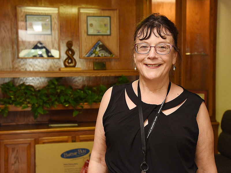 Dr. Marta Nolin poses at entryway of the Missouri Department of Corrections office on Metro Plaza.