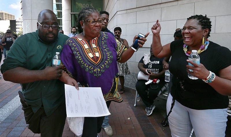 The Rev. Karla Frye is escorted from the Buzz Westfall Justice Center by Rev. Steven Shepard, pastor of St. Peter AME Church, after being released on bond on Sunday, Sept. 24, 2017, in St. Louis. Twenty-two people were arrested Saturday during a march through the Galleria to protest the acquittal of former police officer Jason Stockley in the death of a black man.