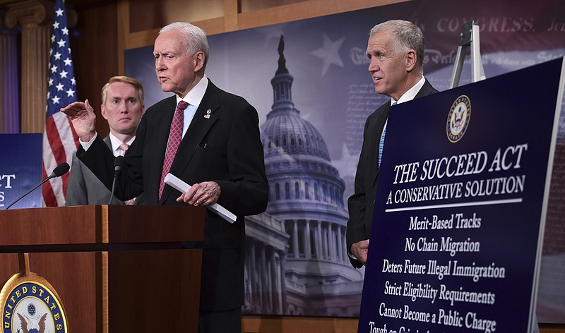 Sen. Orrin Hatch, R-Utah, center, flanked by Sen. James Lankford, R-Okla., left, and Sen. Thom Tillis, R-N.C., right, talk about the legislation they are introducing regarding the legal status of undocumented children during a news conference on Capitol Hill in Washington, Monday, Sept. 25, 2017. (AP Photo/Susan Walsh)