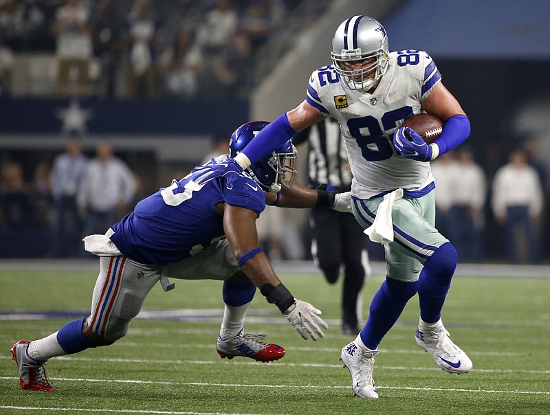 New York Giants linebacker B.J. Goodson (93) gives chase as Dallas Cowboys tight end Jason Witten (82) gains yardage after catching a pass in the first half of an NFL football game Sept. 10 in Arlington, Texas.
