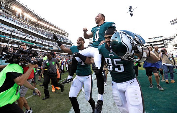 Eagles kicker Jake Elliott is carried off the field after making a game-winning, 61-yard field goal against the Giants on Sunday in Philadelphia.