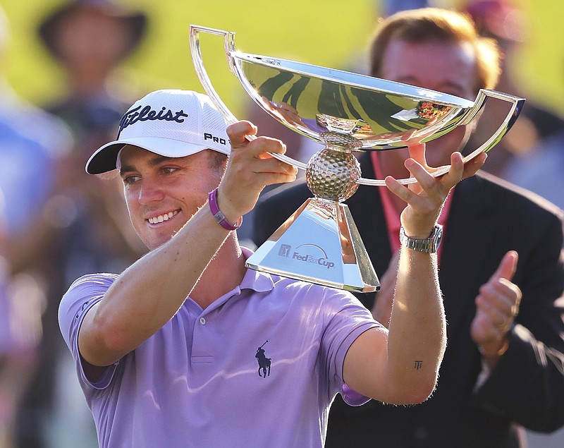 Justin Thomas holds the trophy after winning the Fedex Cup after the Tour Championship golf tournament Sunday at East Lake Golf Club in Atlanta, GA.