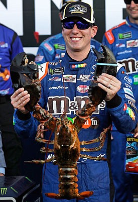 Kyle Busch smiles while holding up a giant lobster Sunday after winning the NASCAR Cup Series race at New Hampshire Motor Speedway in Loudon, N.H.