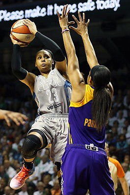 Minnesota forward Maya Moore shoots the ball against the defense of Los Angeles center Candace Parker during the first half of Sunday's game in Minneapolis.