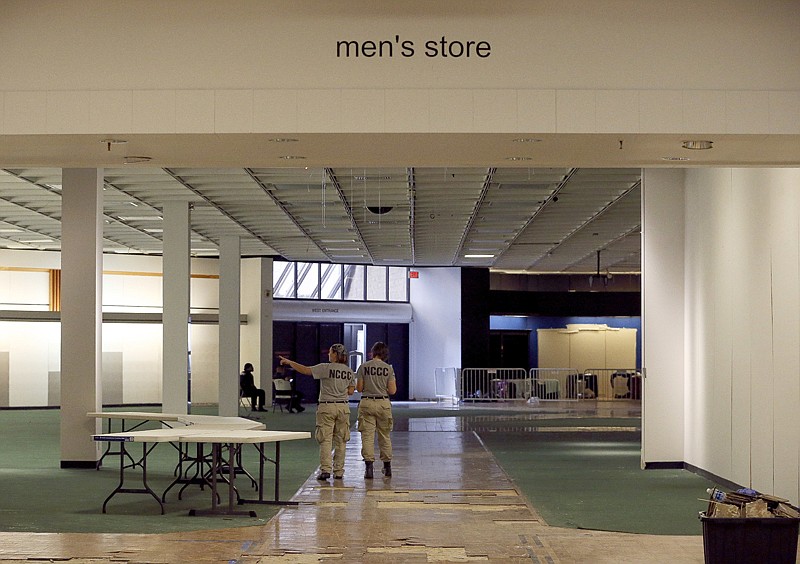 Volunteers from AmeriCorps NCCC, a partner organization with the American Red Cross, scout space Sunday at the vacant Macy's store in Greenspoint Mall to manage inventory supplies and set up a distribution area. The Red Cross moved more than 250 people from a Houston convention center to a new emergency shelter almost a month after Hurricane Harvey displaced thousands.