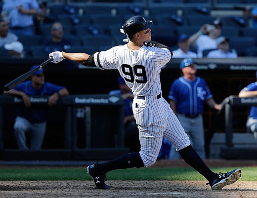 Aaron Judge of the Yankees hits a solo home run during the seventh inning of Monday afternoon's game against the Royals in New York.