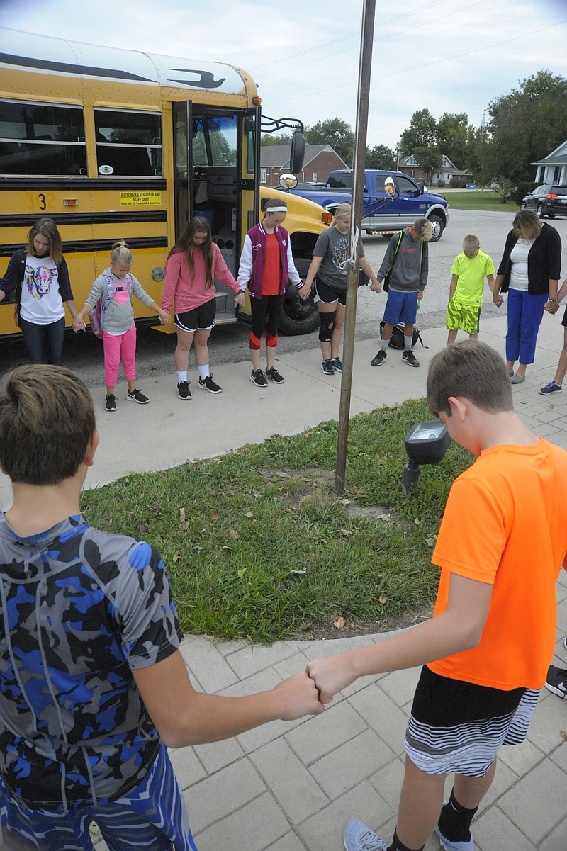 <p>Nearly 30 students gathered for See You At the Pole Sept. 27 at the flag pole on the Russellville middle and elementary school campus. (Democrat photo/Michelle Brooks)</p>