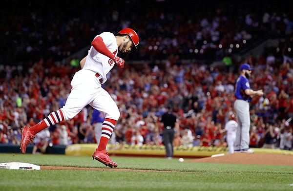 Tommy Pham of the Cardinals rounds the bases after hitting a two-run home run off Cubs starting pitcher Jake Arrieta (right) during the second inning of Tuesday night's game at Busch Stadium.