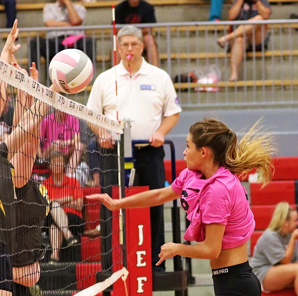 Jefferson City's Stephanie Fisher hits the ball just over the net during Tuesday night's match against Kickapoo at Fleming Fieldhouse.