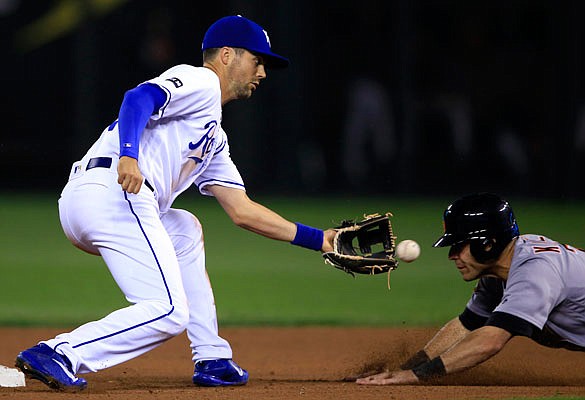 Royals second baseman Whit Merrifield prepares to tag out Ian Kinsler of the Tigers on a stolen base attempt during the sixth inning of Tuesday night's game at Kauffman Stadium.