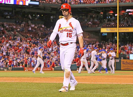 Randal Grichuk of the Cardinals returns to the dugout after making the final out during a baseball game against the Chicago Cubs at Busch Stadium.