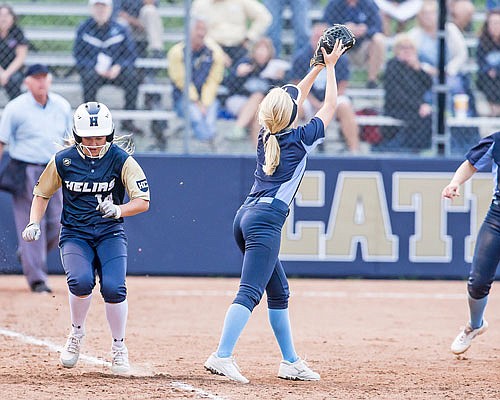 Emily Harrison of Helias beats out a throw to first base during Wednesday night's game against Father Tolton at the American Legion Post 5 Sports Complex.