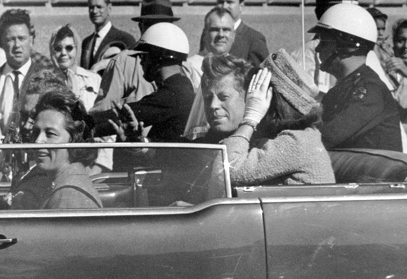 In this Nov. 22, 1963 file photo, President John F. Kennedy waves from his car in a motorcade approximately one minute before he was shot in Dallas. Riding with Kennedy are First Lady Jacqueline Kennedy, right, Nellie Connally, second from left, and her husband, Texas Gov. John Connally, far left. The National Archives has until Oct. 26, 2017, to disclose the remaining files related to Kennedy's assassination, unless President Donald Trump intervenes.