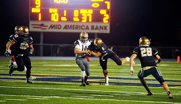 Nathan Bax of Helias makes a tackle during a game against Bishop Althoff earlier this season at Ray Hentges Stadium.