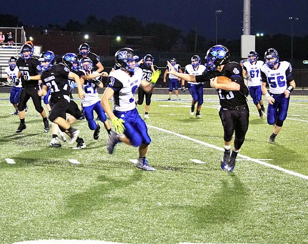 South Callaway senior tailback Kaden Helsel (right) works to separate himself from a Mark Twain defender during the Bulldogs' 49-13 win against the Tigers last Friday in Mokane.