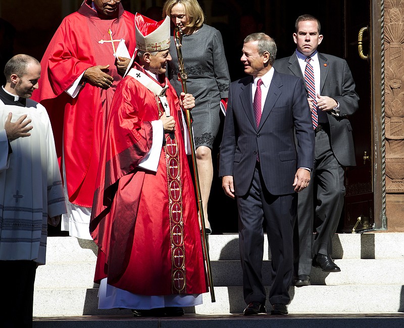 Cardinal Donald Wuerl, Archbishop of Washington, speaks with U.S. Supreme Court Chief Justice John Roberts as they leave St. Mathews Cathedral after the Red Mass in Washington on Sunday, Oct. 1, 2017. The Supreme Court's new term starts Monday, Oct. 2. (AP Photo/Jose Luis Magana)