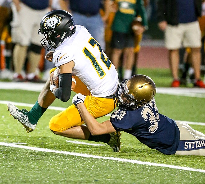 Austin Radmacher of Helias pulls down Trevor Twehous of Rock Bridge Saturday, Oct. 1, 2017 during the Crusaders' Homecoming game at Ray Hentges Stadium. 