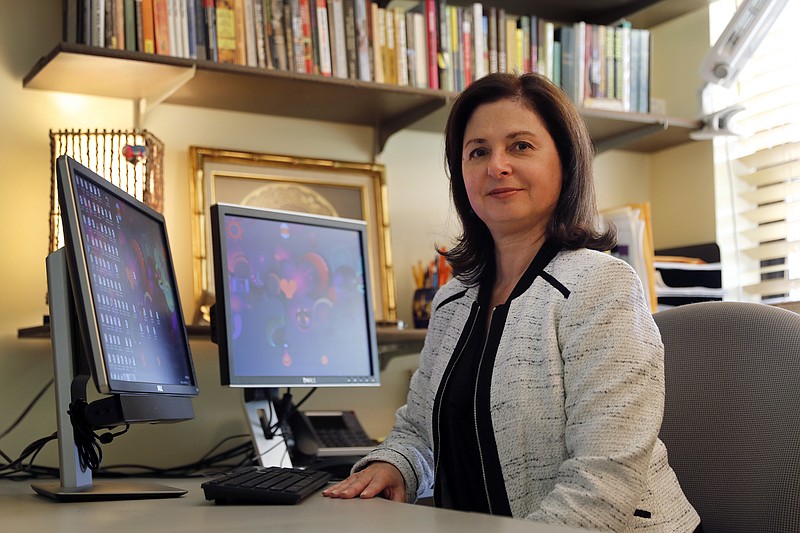 In this Sept. 5, 2017, photo, sociologist Lisa Martino-Taylor poses for a photo in her office in Kirkwood, Mo. Martino-Taylor wrote in a recently released book that the U.S. government secretly exposed hundreds of thousands of people to dangerous radiation, along with chemical and biological materials in Cold War-era testing, including impoverished residents in St. Louis, poor pregnant women in the South and high school students in California. (AP Photo/Jeff Roberson)