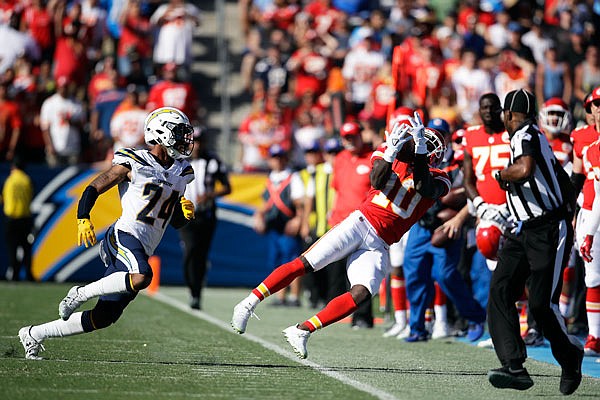 Tyreek Hill of the Chiefs catches a pass as he is followed by Trevor Williams of the Chargers during last Sunday's game in Carson, Calif.