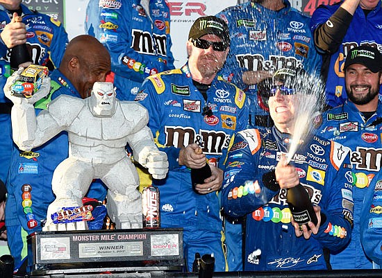 Kyle Busch (front right) celebrates Sunday after winning the NASCAR Cup race at Dover International Speedway in Dover, Del.