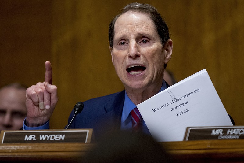 FILE - In this Sept. 25, 2017, file photo, Sen. Ron Wyden, D-Ore., speaks on Capitol Hill in Washington. Wyden wants to know how well prepared the country’s top voting machine manufacturers are against hackers. In letters shared with The Associated Press, Wyden asks the CEOs of six election technology firms to answer a range of questions detailing how they protect sensitive voter data and test their own internal security systems.(AP Photo/Andrew Harnik, file)