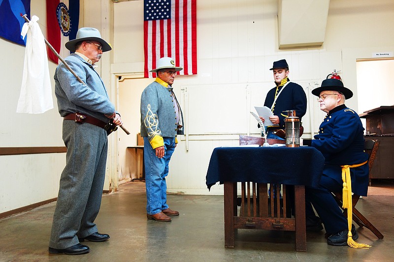 Local history enthusiasts reenact the 1861 meeting between Col. Jefferson Jones' and Gen. John B. Henderson's men. Here, Henderson (played by Warren Hollrah, right) receives a missive from Jones.