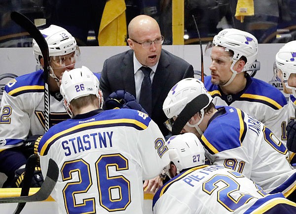In this May 2 file photo, Blues coach Mike Yeo talks to his players during the third period in Game 4 of a second-round NHL playoff series against the Predators in Nashville, Tenn.