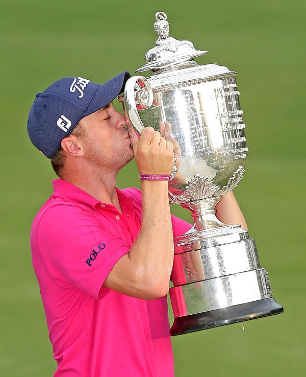 In this Aug. 13 file photo, Justin Thomas poses with the Wanamaker Trophy after winning the PGA Championship at the Quail Hollow Club in Charlotte, N.C. Thomas was announced Wednesday as the PGA Tour player of the year.