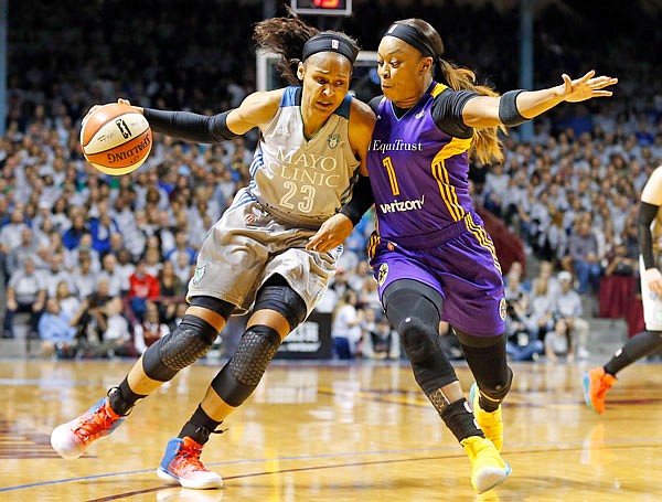 Maya Moore of the Lynx drives around Odyssey Sims of the Sparks in the first half in Game 5 of the WNBA Finals on Wednesday in Minneapolis.