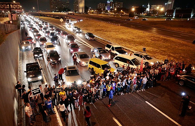 Protesters stop traffic Tuesday, Oct. 3, 2017 on Interstate 64 eastbound at the Compton Avenue overpass in St. Louis. After marching to Jefferson Avenue and exiting the highway, most of the group was arrested for being on the interstate as part of the ongoing demonstrations against the acquittal of a white former police officer in the 2011 killing of a black man.