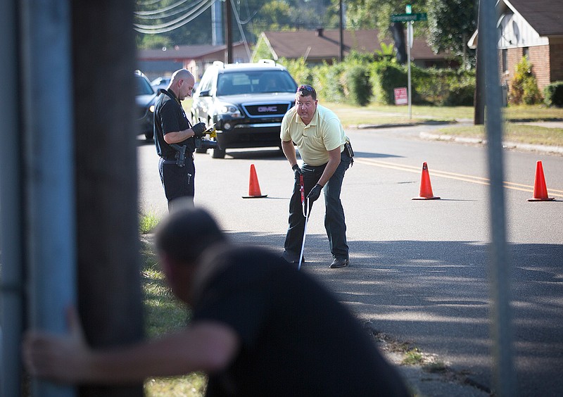 Texarkana, Ark., Police Department detectives and crime scene technicians collect evidence Oct. 5 at the scene of a shootout on 35th Street in front of the Quill Creek Apartments. According to police reports, a dispute erupted into gunfire and two people were taken to the hospital with nonlife-threatening injuries.