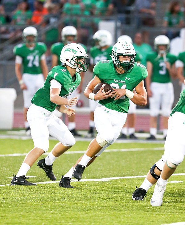 Braydan Pritchett of Blair Oaks carries the ball after taking the handoff from quarterback Cade Stockman during last month's game against Southern Boone at the Falcon Athletic Complex in Wardsville.