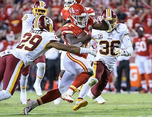 Chiefs running back Kareem Hunt tries to run past Redskins cornerback Kendall Fuller during the second half of Monday night's game at Arrowhead Stadium.