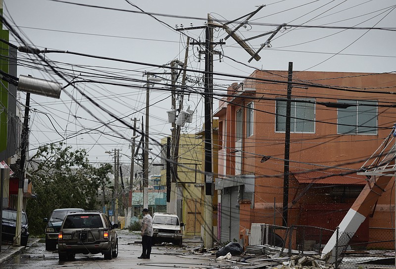 FILE - In this Wednesday, Sept. 20, 2017 file photo, power lines are down after the impact of Hurricane Maria, which hit the eastern region of the island in Humacao, Puerto Rico. In the wake of Hurricane Maria, Facebook pledged to send a "connectivity team" to help restore communications in ravaged Puerto Rico. It's just one of several tech companies - among them Tesla, Google, Cisco, Microsoft and a range of startups - with their own disaster response proposals, most aimed at getting phone and internet service up and running. (AP Photo/Carlos Giusti, File)