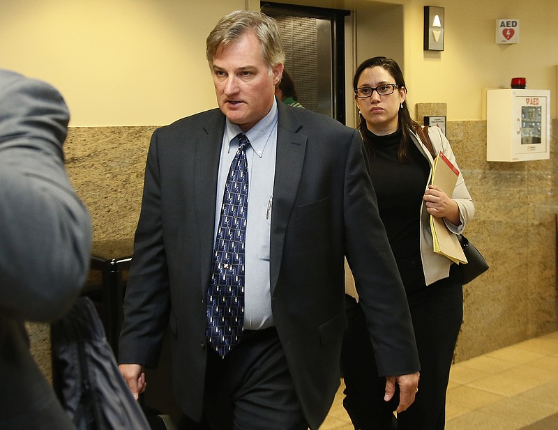 FILE - In this Friday, June 30, 2017 file photo, ex-Tulsa police officer Shannon Kepler, left, arrives with his legal team for afternoon testimony in his trial in Tulsa, Okla. Kepler is headed for a fourth trial in less than a year in the 2014 fatal shooting of his daughter's black boyfriend. (AP Photo/Sue Ogrocki, File)