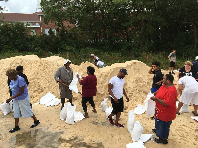 People fill sandbags to prepare for Hurricane Nate in Moss Point, Miss., on Saturday, Oct. 7, 2017. Storm surge threatens many low-lying neighborhoods in city, which was heavily flooded during 2005's Hurricane Katrina. (AP Photo/Jeff Amy)