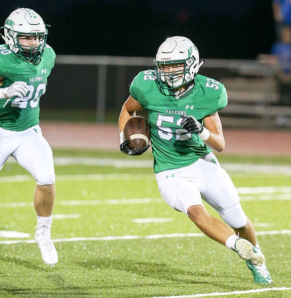 Blair Oaks linebacker Drew Boessen looks for room to run after grabbing an interception during the first quarter of Friday night's game against California at the Falcon Athletic Complex.