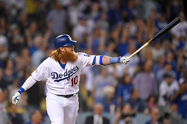 Justin Turner of the Dodgers watches his three-run home run against the Diamondbacks during the first inning of Game 1 of the National League Division Series on Friday in Los Angeles.