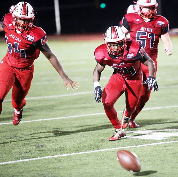 Jays linebacker Elijah Jackson (right) runs down a loose ball during Friday's Homecoming game against Battle at Adkins Stadium.