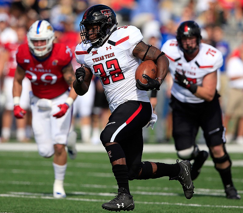 Texas Tech running back Desmond Nisby (32) runs for a 47-yard touchdown during the first half of an NCAA college football game against Kansas in Lawrence, Kan., Saturday, Oct. 7, 2017.
