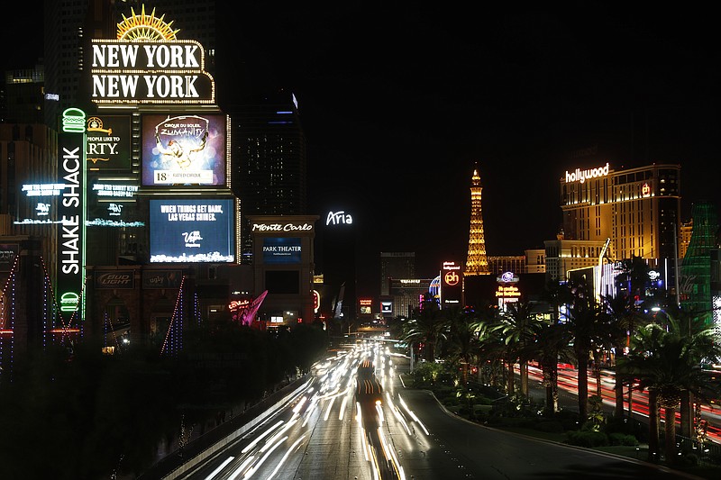 Some of the casinos along the Las Vegas Strip dim their marquees signs for about 10 minutes Sunday, Oct. 8, 2017, in Las Vegas, to pay tribute to the victims who spent that much time under fire in the Las Vegas shooting on Sunday, Oct. 1. (AP Photo/Steve Marcus)