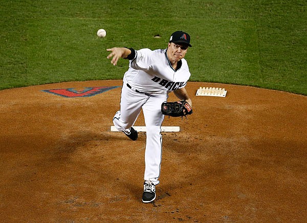 Diamondbacks starting pitcher Zack Greinke throws to the Rockies during the first inning of last Wednesday's National League wild-card playoff game in Phoenix.