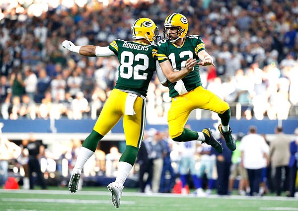 Packers tight end Richard Rodgers (left) and quarterback Aaron Rodgers celebrate a touchdown in the final seconds of the second half during Sunday's game against the Cowboys in Arlington, Texas.