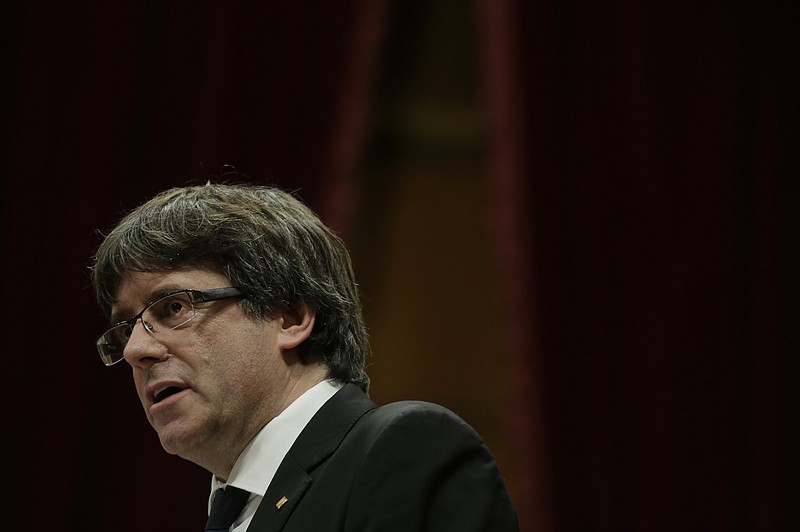 Catalan regional President Carles Puigdemont delivers his opening speech at the parliament in Barcelona, Spain, Tuesday, Oct. 10, 2017. Puigdemont says he has a mandate to declare independence for the northeastern region, but proposes waiting "a few weeks" in order to facilitate a dialogue. (AP Photo/Manu Fernandez)