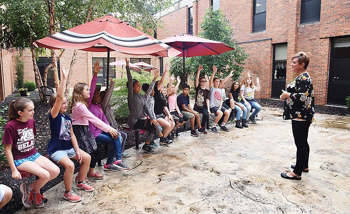 Fifth-grade teacher Holly Watson, right, occasionally brings her students out into the Belair Elementary courtyard for class. The courtyard is a nearly decade-old addition to the school and is a favorite of many students and faculty.