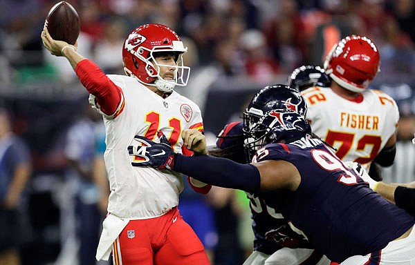 Chiefs quarterback Alex Smith is pressured by Texans defensive end Christian Covington during the first half of Sunday night's game in Houston.