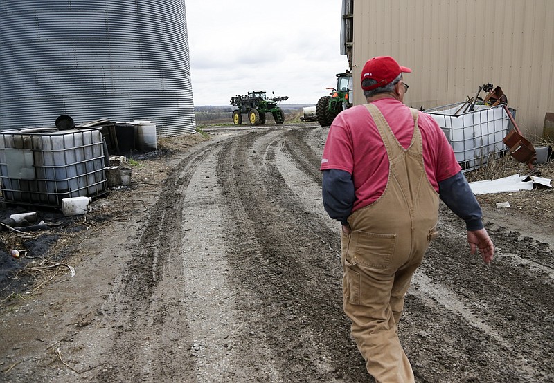 FILE - In this Tuesday, April 4, 2017, file photo, Blake Hurst, a corn and soybean farmer and president of the Missouri Farm Bureau, walks to the tractor shed on his farm in Westboro, Mo.