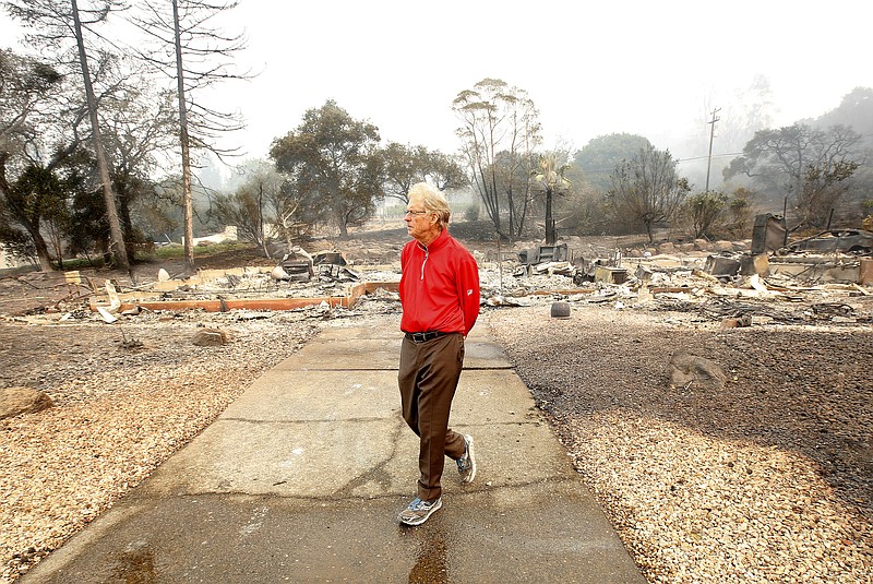 <p>AP</p><p>Mike Rippey walks away from the burned out remains of his parents home at the Silverado Resort in Napa, California. Charles Rippey, 100 and his wife Sara, 98, died when wind whipped flames swept through the area Sunday night.</p>